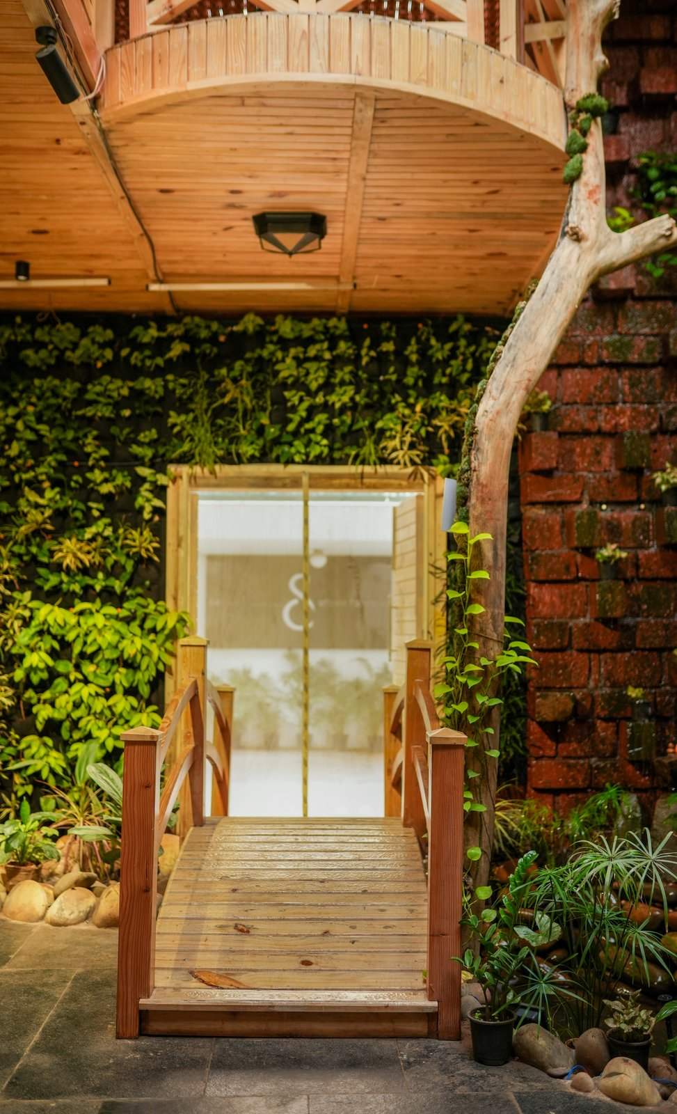 The bridge and lit threshold leading behind the café